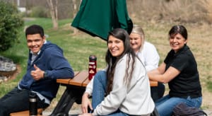 KaTom employees sitting at picnic table