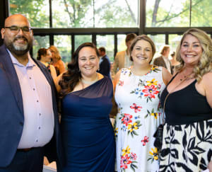 Group of four people smiling in photo