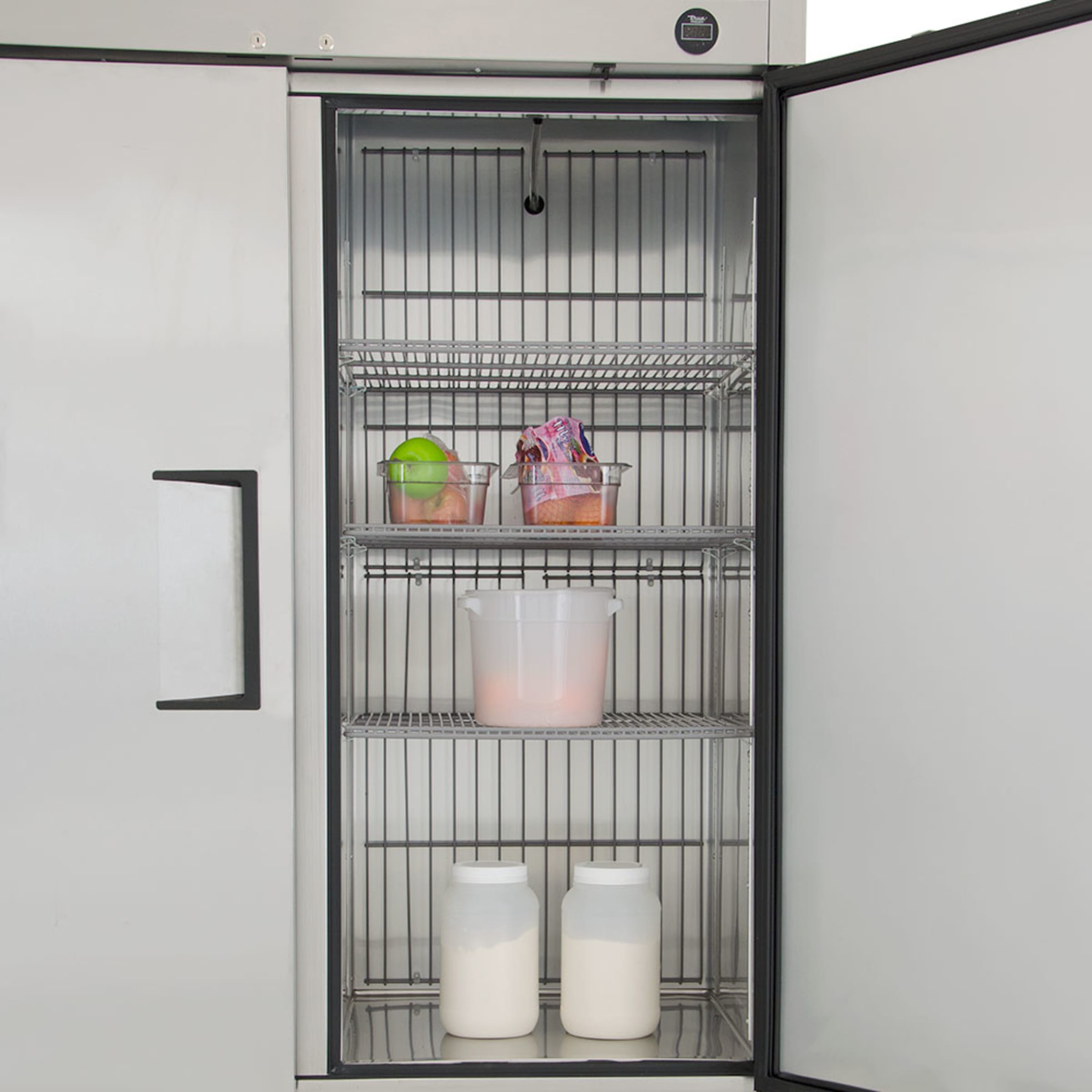 Interior view of the right compartment with wire shelves holding food containers