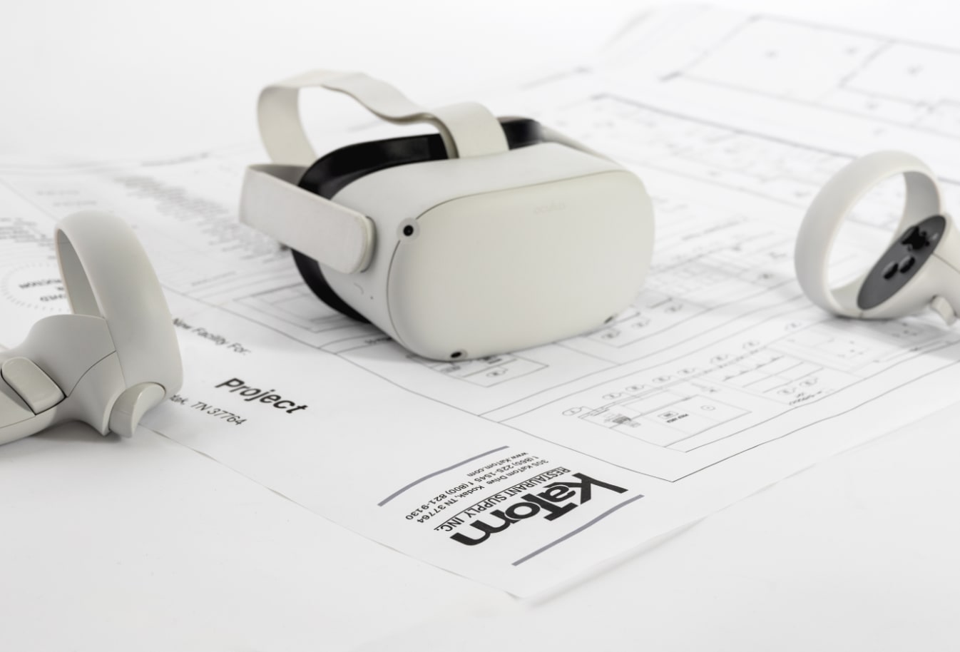 Image with an Oculus Rift on top of building plans